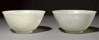 19th Century A pair of translucent pale celadon speckled jade bowls